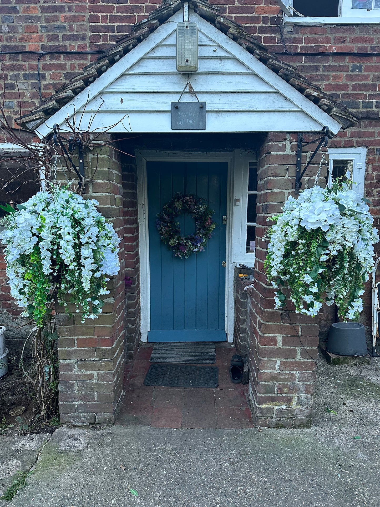 White faux flowers/ foliage full cone hanging baskets.