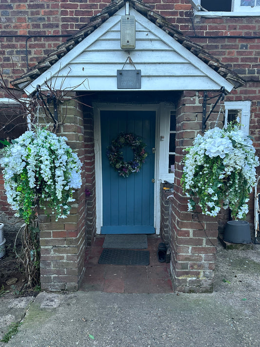 White faux flowers/ foliage full cone hanging baskets.