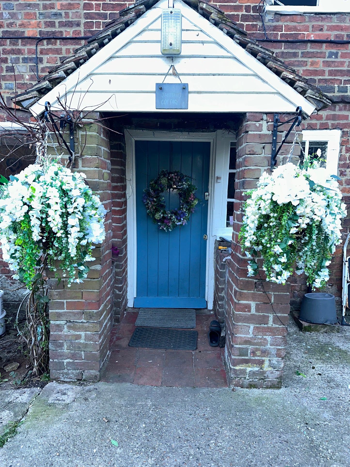 White faux flowers/ foliage full cone hanging baskets.