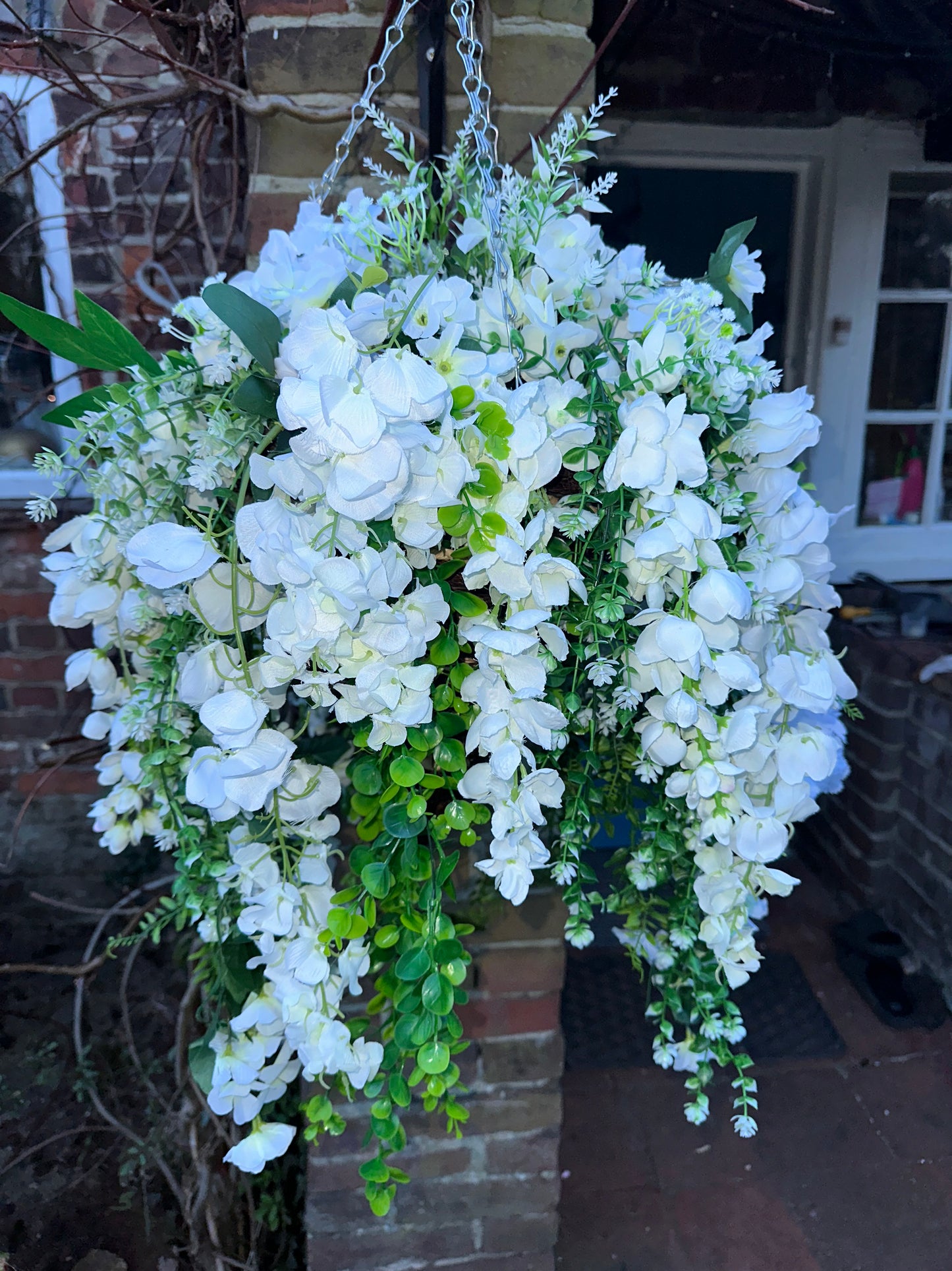 White faux flowers/ foliage full cone hanging baskets.